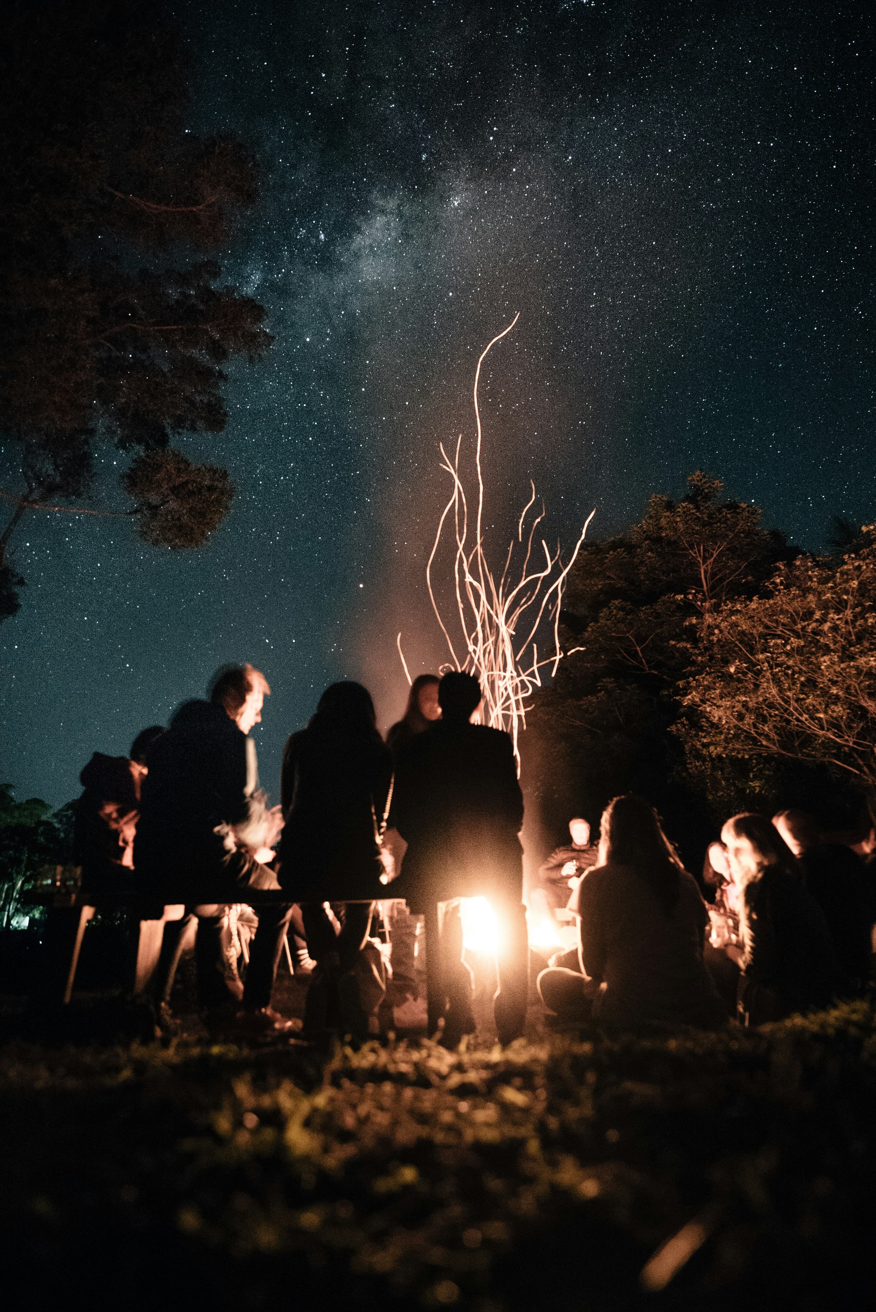 Veterans in community gathered around a fire
